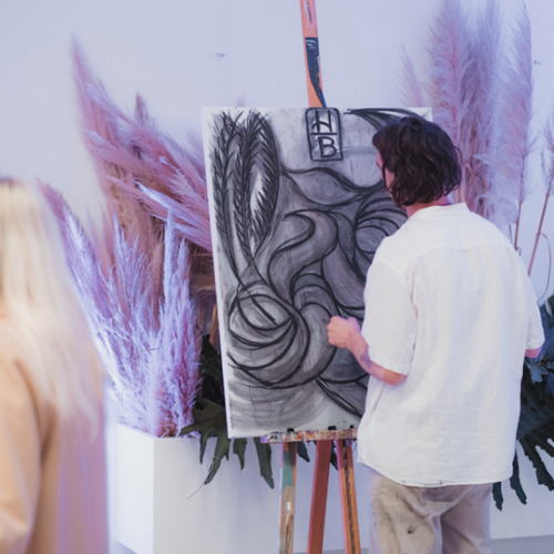 Artist, Blake Feeney paints a live art installation for Hummingbird Coffee